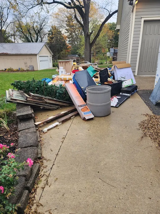 Dumpster being loaded with debris for 12 Yard Dumpster Rental in Corrales
